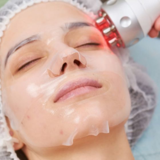 Facial hydrogel mask close up. Woman undergoing skin treatment.